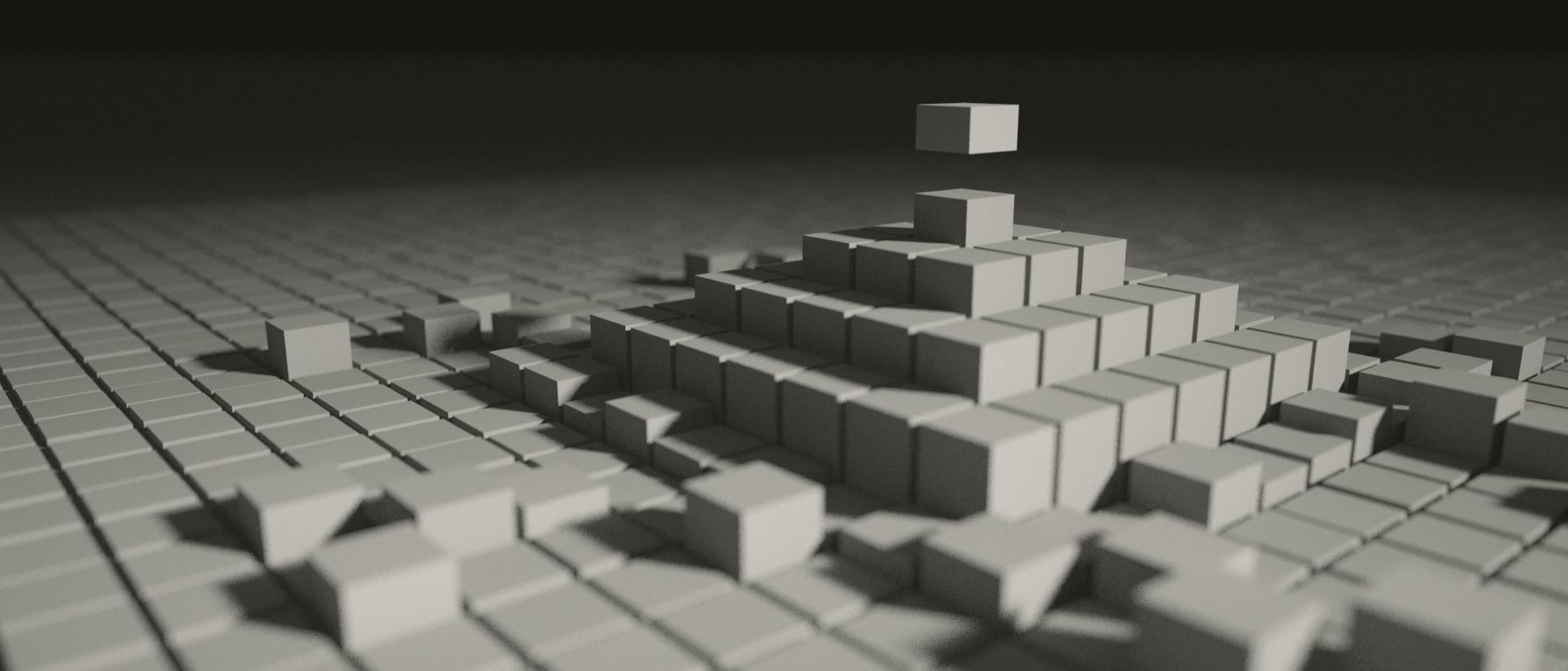 A field of square stone blocks with a stepped structure rising from it, its last block hovering above the top.